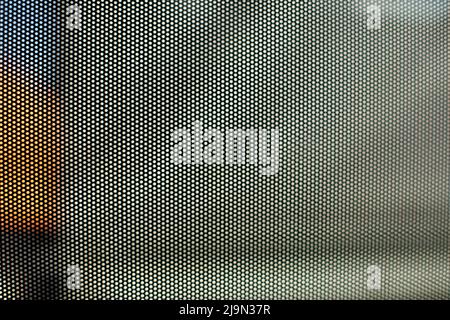Mesh texture on glass. Shooting window. Small cage. Textured surface. Stock Photo