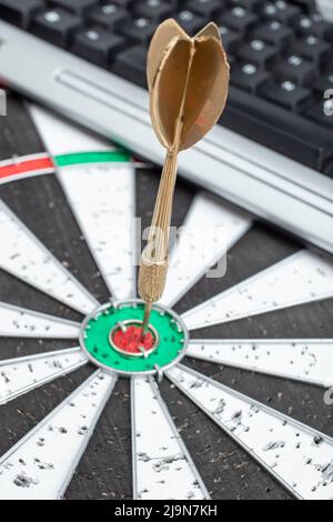 golden arrow dart in the middle of an dart board Stock Photo