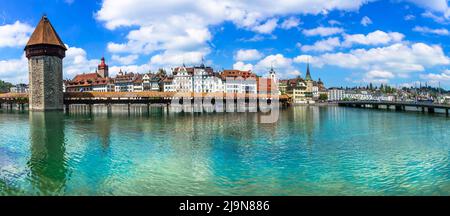 Panoramic view of Lucerne (Luzern) town with famous Chapel wooden bridge over Reuss river.  Switzerland travel and landmarks. Stock Photo