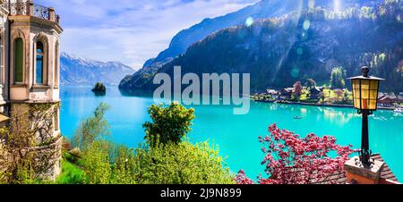 Stunning idylic nature scenery of lake Brienz with turquoise waters. Switzerland, Bern canton. Iseltwald village surrounded turquoise waters Stock Photo