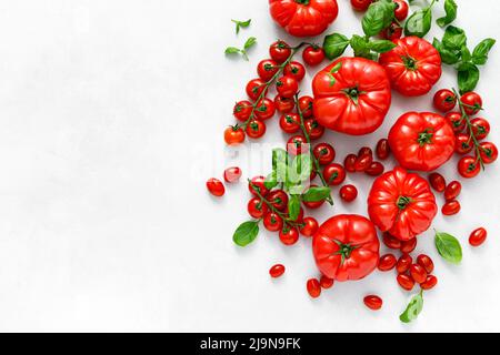 Tomatoes and basil on white background, top view, flat lay Stock Photo