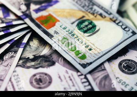 American paper dollar bills background. Hundred dollar banknotes texture, currency concept with tilt-shift effect Stock Photo