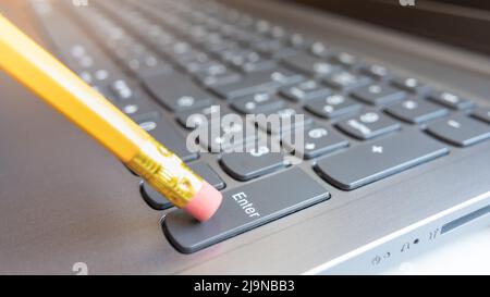 Pen by pressing the enter key on a computer keyboard. Stock Photo