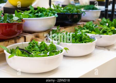 Salad bar with fresh greens in hotel buffet. Concept of healthy eating Stock Photo
