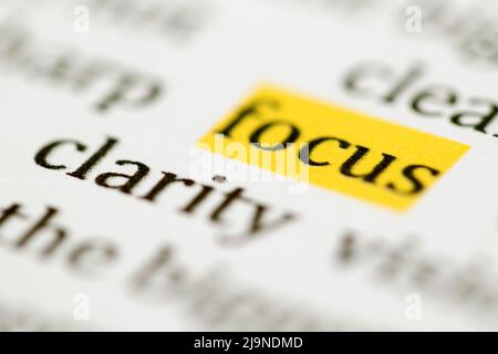 Close up of the typed word focus highlighted in yellow and printed in black ink on white ink jet paper Stock Photo