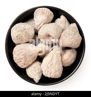 Dusted dried baby figs in a black ceramic bowl isolated on white. Top view. Stock Photo