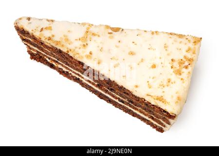 Slice of carrot cake with cream cheese filling and frosting isolated on white. Top view. Stock Photo