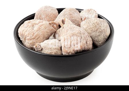 Dusted dried baby figs in a black ceramic bowl isolated on white. Stock Photo