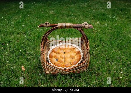 Traditional homemade Czech pastry from yeast dough.Mini cakes stuffed with sweet cream cheese and plum jam in rustic basket.Czech cuisine,picnic scene Stock Photo