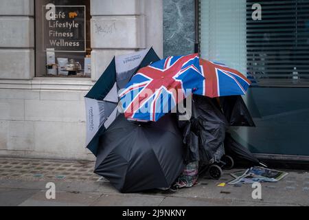 London, UK. 24th May 2022. A rough sleeper's tent constructed from umbrellas seen during the day near Sloane Square. Credit: Guy Corbishley/Alamy Live News Stock Photo