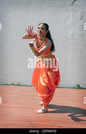 An attractive teenage dancer from the Avantikas group performs at tte Bollywood & Indian Folk Fusion Dance Concert in Charles Drew Park in Queens, NYC Stock Photo