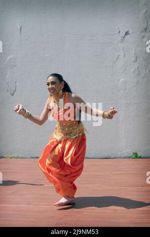 An attractive teenage dancer from the Avantikas group performs at tte Bollywood & Indian Folk Fusion Dance Concert in Charles Drew Park in Queens, NYC Stock Photo