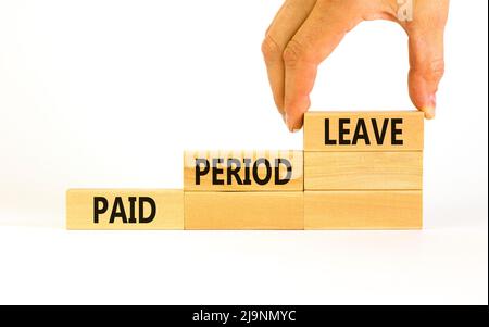 Paid period leave symbol. Concept words Paid period leave on wooden blocks. Beautiful white table white background. Doctor hand. Business medical paid Stock Photo