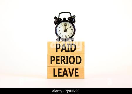 Paid period leave symbol. Concept words Paid period leave on wooden blocks. Black alarm clock. Beautiful white table white background. Business medica Stock Photo