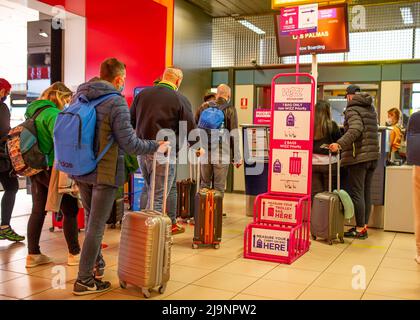 20 April 2022 Passengers passing through Henry Coanda airport in Bucharest and waiting or going to boarding with their suitcases being guided by the a Stock Photo