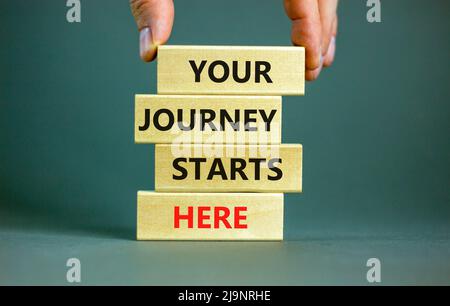 Your journey starts here symbol. Concept words Your journey starts here on wooden blocks on a beautiful grey table grey background. Business, motivati Stock Photo