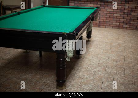 Game of billiards. Billiard accessories. Cue for hitting balls. Game table. Stock Photo