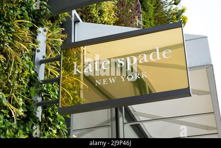 Close up of Kate Spade New York fashion shop sign at Ashford Outlet Center, Kent, England, UK. Stock Photo