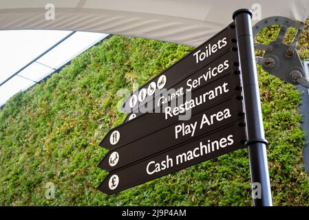 Wayfinder multi directional signage arrows at Ashford Outlet Center, Kent, England, UK. Toilets etc. Stock Photo