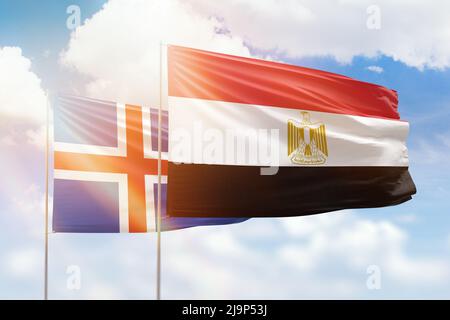 Sunny blue sky and flags of egypt and iceland Stock Photo