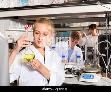 Female student examining chemicals Stock Photo