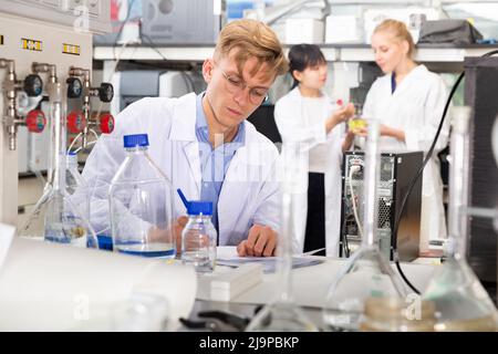 Male scientist working at biochemical laboratory Stock Photo