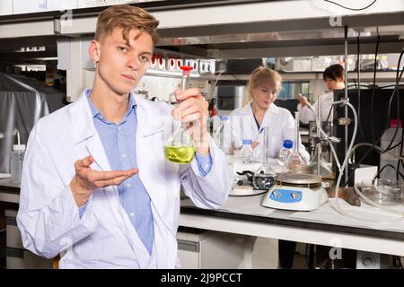 Male scientist holding flask of reagent Stock Photo