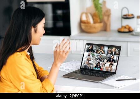 Virtual business meeting. Asian woman talking by video call with multiracial business group, discussing project, brainstorming with colleagues online, develop successful project, start-up Stock Photo