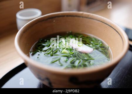 A bowl of matcha soba in warm gyokuro tea broth at Tsujiri, a traditional Japanese restaurant at Daimyo Department Store in Tokyo Station — Marunouchi Stock Photo