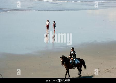 Park police on horseback on beach in San Francisco, California in 1979 Stock Photo