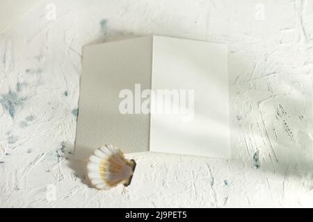 Modern stationery still life with warm sunlight. Closeup foto of blank card mock-up.  Stock Photo