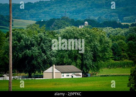 An Amish One Room School House in the Middle of Rich Farmlands on a Sunny Summer Day Stock Photo