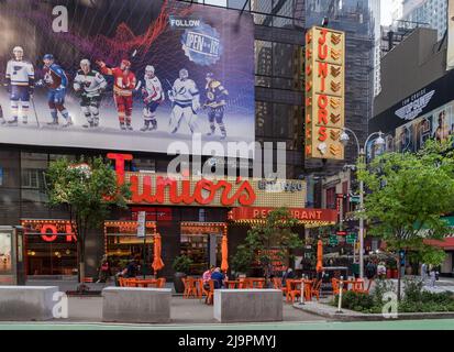 New York, NY - USA - May 20, 2022 Horizontal view of Times Square Junior's Restaurant. The Brooklyn-themed landmark located near the corner of Broadwa