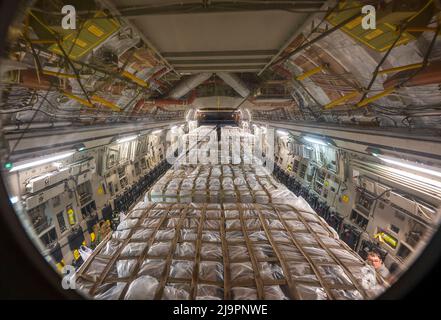 A C-17 Globemaster III assigned to Joint Base Pearl Harbor-Hickam, Hawaii carries pallets of infant formula at Ramstein Air Base, Germany, May 22, 2022. Hundreds of boxes of infant formula arrived from Switzerland and were unloaded, palletized and loaded on a C-17 for transport during Operation Fly Formula, an operation to quickly import infant formula to the United States that meets U.S. health and safety standards. (U.S. Air Force photo by Staff Sgt. Jacob Wongwai) Stock Photo