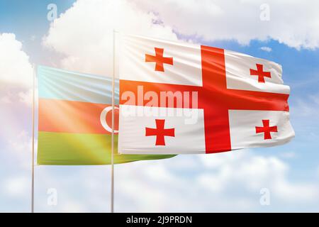 Sunny blue sky and flags of georgia and azerbaijan Stock Photo