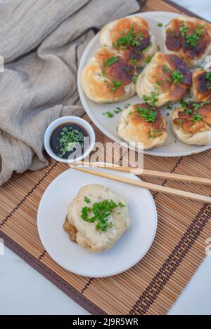 Shanghai pan fried pork dumpling with wild garlic Stock Photo