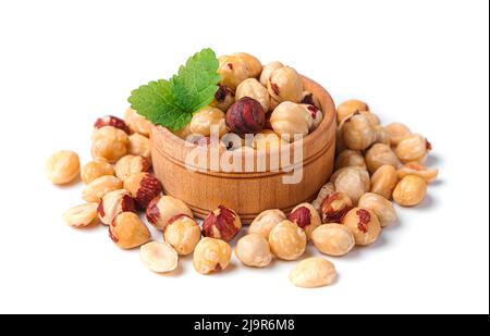 Peeled hazelnuts in a wooden bowl on a white background. Stock Photo