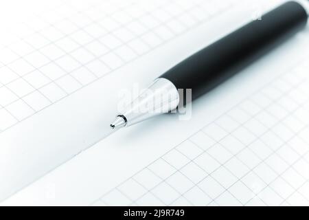 Ball pen and office pad, focus on the pen tip Stock Photo
