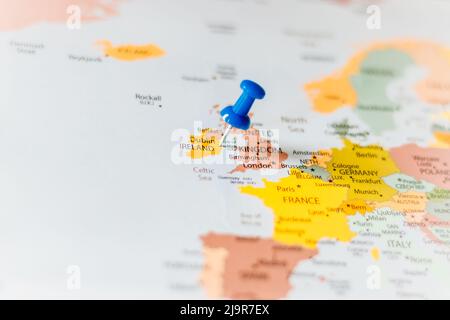 Blue push pin pointing at Ireland on a political world map Stock Photo