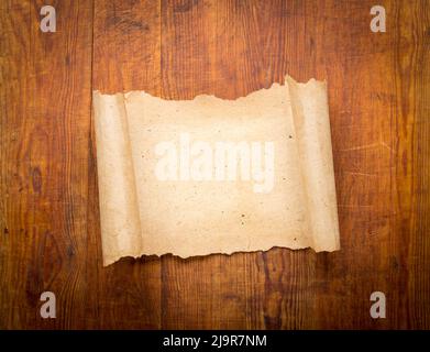 parchment scroll on wooden background. Stock Photo