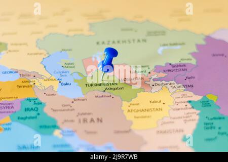 Blue push pin pointing at Turkmenistan on a political world map Stock Photo