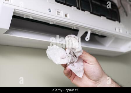 the master washes the home air conditioner. dirty rag close-up Stock Photo