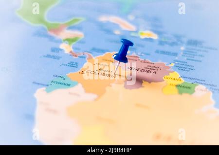 Blue push pin pointing at Colombia on a political world map Stock Photo