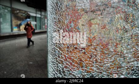 Berlin, Germany. 15th Apr, 2022. A shattered window of a phone booth is seen at Hermannplatz in Neukölln. Credit: Stefan Jaitner/dpa/Alamy Live News Stock Photo