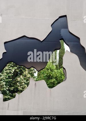 Wall with a hole where you can see trees. Concept, nature, green. Stock Photo