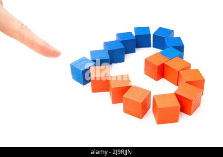 Finger pointing on a heart symbol made from red and blue wooden blocks on white. Stock Photo