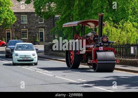 Red black stationary heavy steam-powered vehicle parked at roadside (L-plate on front) overtaken - Burley-in-Wharfedale, West Yorkshire, England, UK. Stock Photo