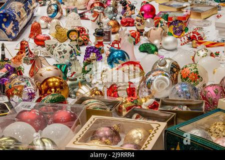 Christmas decorations on table ready to hang on Christmas tree. Stock Photo