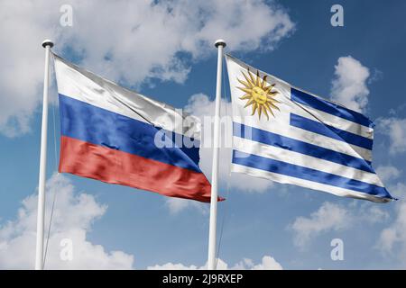 Russia and Uruguay two flags on flagpoles and blue cloudy sky background Stock Photo