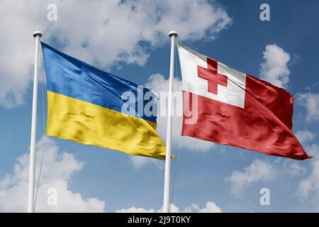 Ukraine and Tonga two flags on flagpoles and blue cloudy sky background Stock Photo